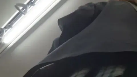 Blonde with Tattoo Takes Selfie in Bathroom