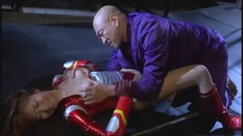 Blonde in Red Costume in Dark Industrial Setting