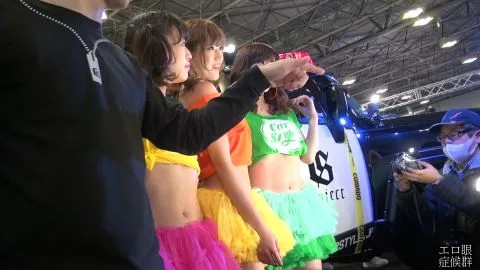 Asian Models Posing Near Cars