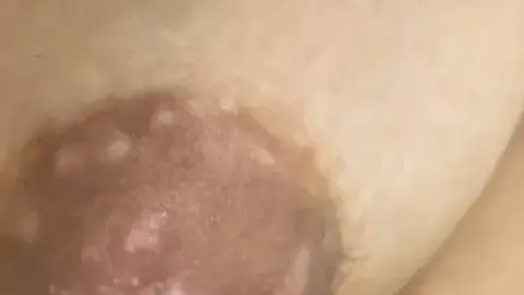 Asian Teen with Large Breasts Topless in Bedroom