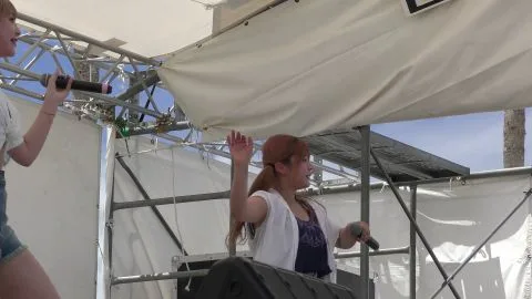 Teen Girls Singing on Outdoor Stage