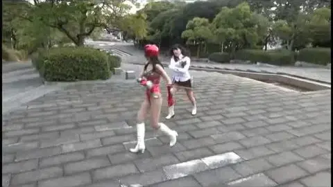 Asian Performers in Costumes Engage in Play-Fighting