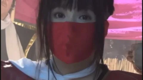 Asian woman in red costume in bondage scenes