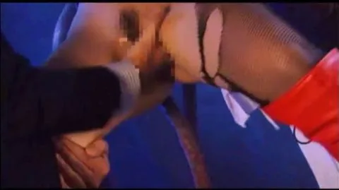 Woman in Red Costume Explicit Scene