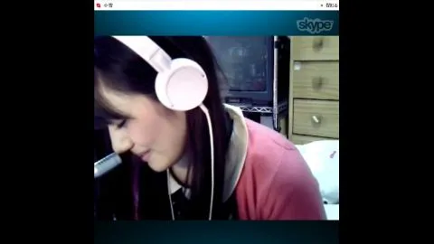 Asian girl with pink headphones in bedroom