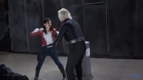 Dark Haired Woman Fights in Industrial Setting