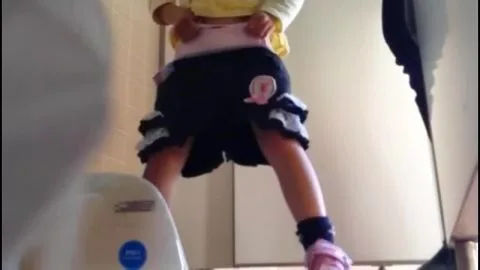 Woman Urinating in Toilet