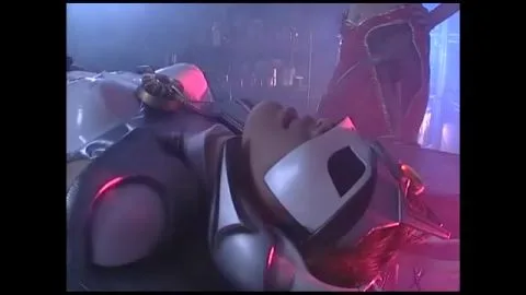 Asian Performers in Silver Costumes Engage in Intimate Acts