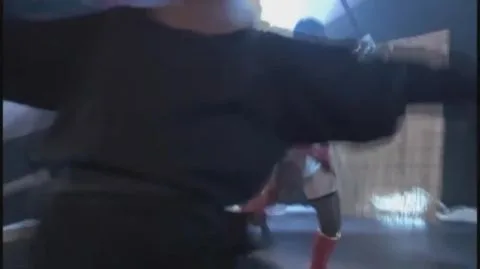 Asian Couple in Red Costume Engage in Erotic Sword Fight