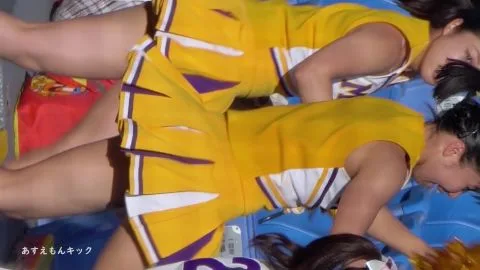 Asian Cheerleaders in Yellow Uniforms Dancing