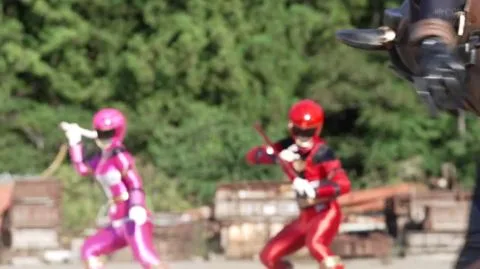 Asian Performers in Costumes Engage in Intimate Scenes