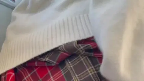 Asian Schoolgirl in Red Plaid Skirt on Train