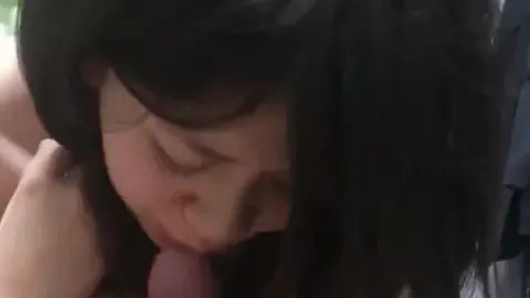 Asian woman performs oral sex