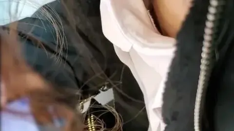 Asian girl in ripped jeans and gold necklace