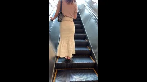 Woman in beige outfit walking outdoors