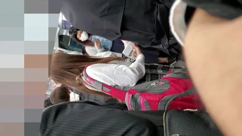 Asian teens on subway escalator