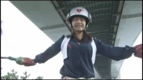 Asian Women in Futuristic Outfits and Helmets