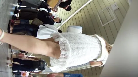 Blonde Woman in White Dress with Man in Hallway