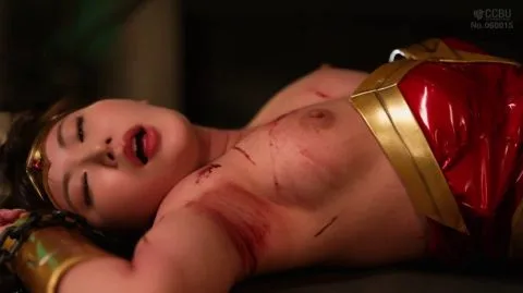 Asian woman in Wonder Woman costume with bruises gets intimate in dark