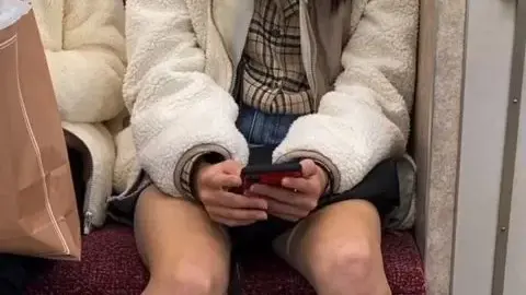 Asian teen on train with shopping bags