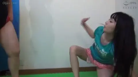 Asian Women Engaging in Wrestling Match