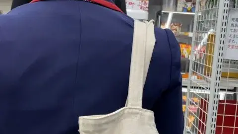 Asian in Blue Uniform with ‘JAPAN’ Tote Bag
