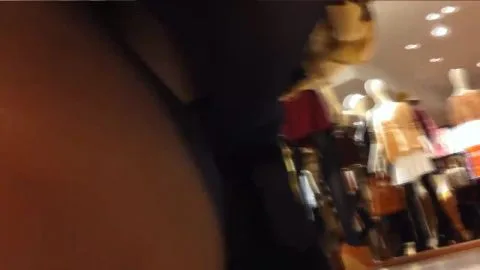 Asian Girl Tries On Dresses in Clothing Store