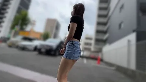 Asian Girl in Denim Shorts on City Street