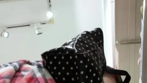 Asian Teen in Plaid Shirt Reaches into Bag