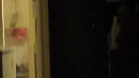 Asian Girl Drying Off in Dimly Lit Bathroom