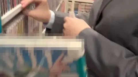 Asian Girl in Mask and Blazer in Manga Store