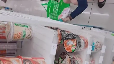 Asian Couple Intimate Moment in Supermarket