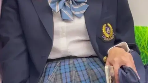 Asian Teen in School Uniform on Train