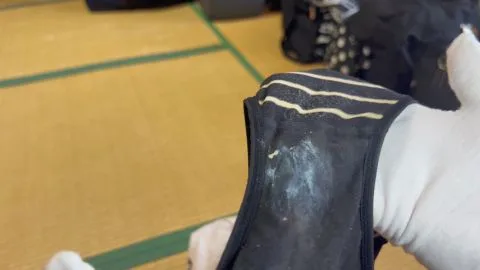 Asian woman in white gloves on tatami mat