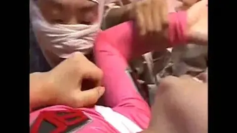 Asian Performers Engaged in Restraint and Gagging