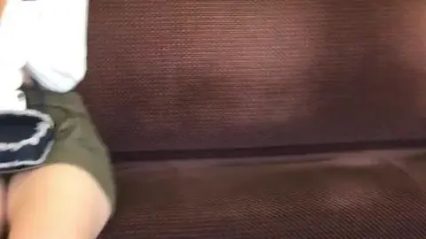 Asian Teen in Green Shorts on Public Transportation