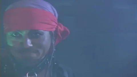 Red and Silver Costumed Performers in Erotic Scene