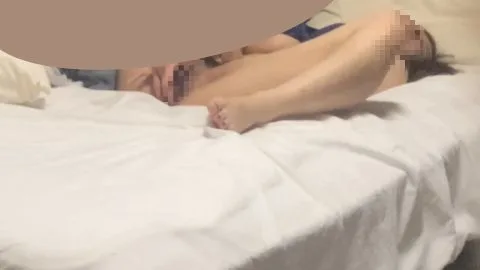 Asian Teen Lies on Bed with Legs Raised