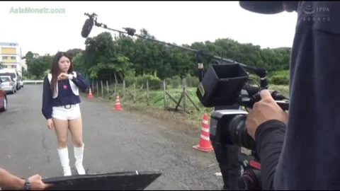Asian Performer in White Boots and Shorts in Industrial Setting