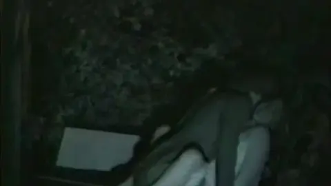 Couple Embracing in Garden at Night